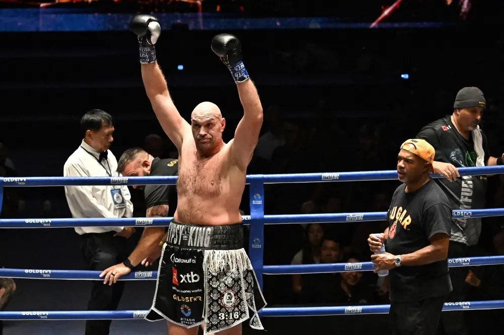 Tyson Fury raising both gloves in the ring